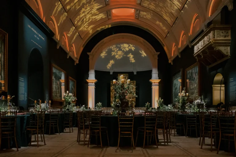 Beautiful dinner setup in the V&A Museum, with colours of peach and forest green.